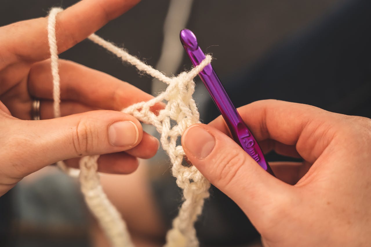 Hands crocheting with purple hook - Learn Crochet Easily